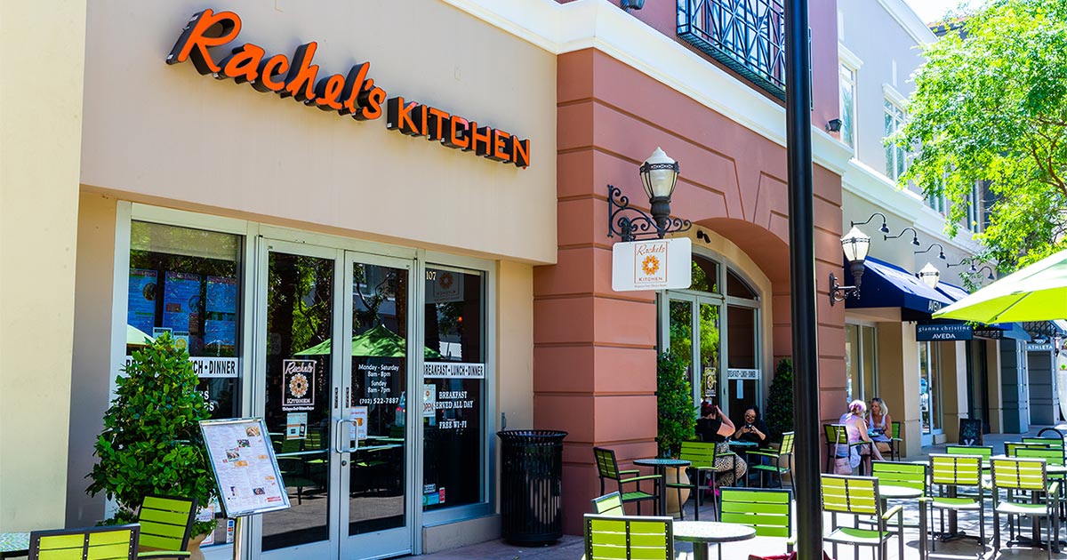 Rachel's Kitchen restaurant storefront with orange signage and outdoor patio seating in Las Vegas